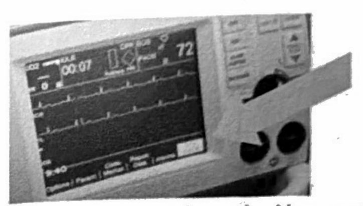 The monitor with the sync button being pressed.